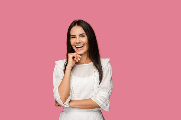 happy woman touching face and laughing isolated on pink 