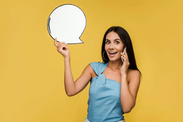 Happy Girl Holding Blank Speech Bubble While Talking Smartphone Isolated — Stock Photo, Image