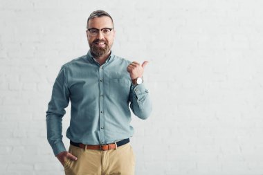 handsome businessman in shirt showing thumb up and looking at camera 