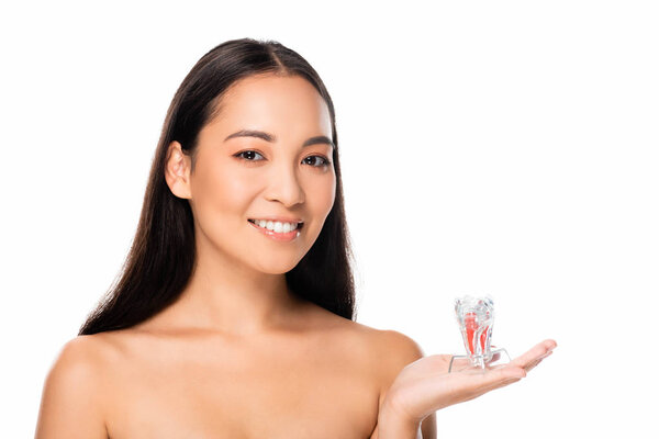 happy naked asian woman holding tooth model isolated on white with copy space