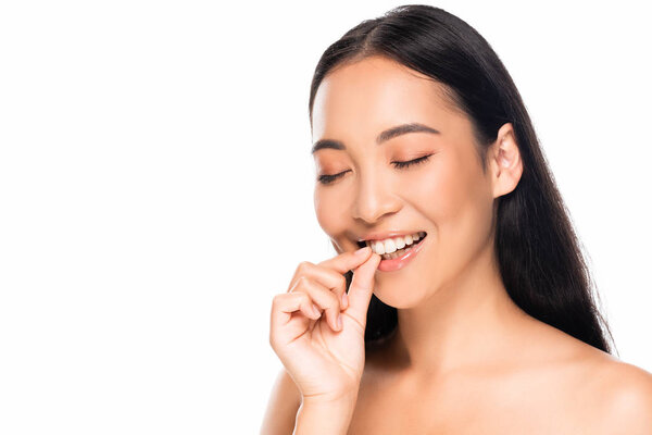 smiling beautiful asian woman showing white teeth with closed eyes isolated on white