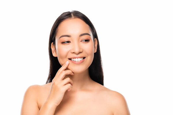 smiling beautiful asian woman with white teeth looking away isolated on white