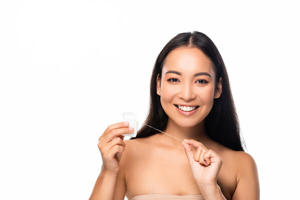 smiling asian woman with dental floss isolated on white