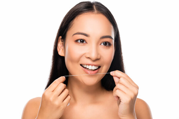 smiling asian naked woman holding dental floss isolated on white