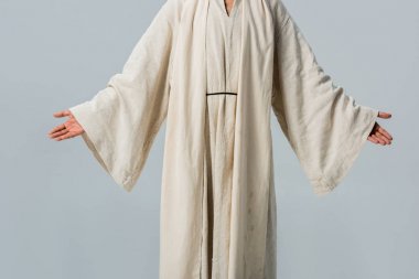 cropped view of man in jesus robe with outstretched hands isolated on grey  clipart