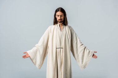 man in jesus robe standing with outstretched hands isolated on grey clipart