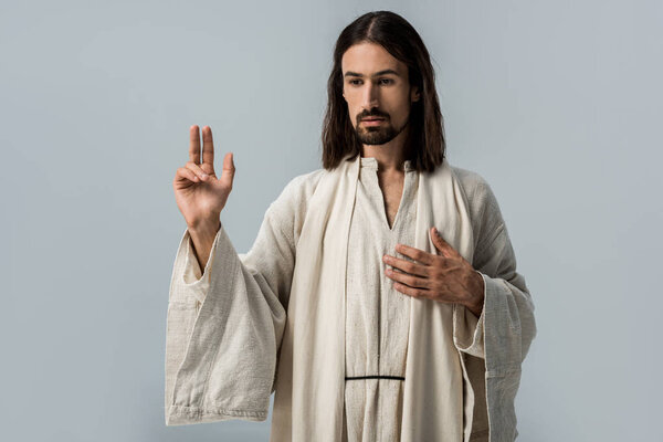 religious man in jesus robe gesturing isolated on grey 