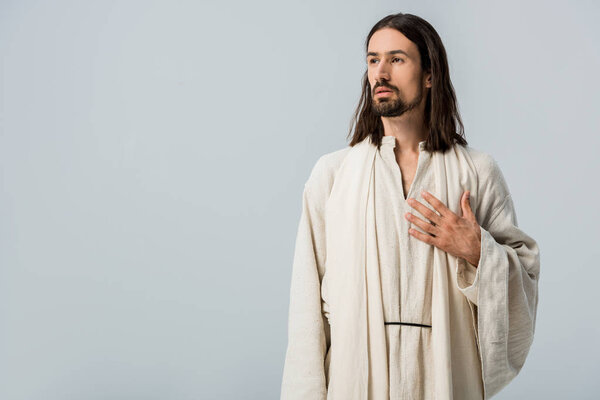 religious man with hand on chest isolated on grey 