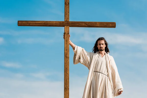 Handsome Man Standing Holding Wooden Cross — Stock Photo, Image