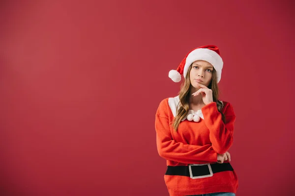 Attractive Pensive Woman Santa Hat Sweater Looking Camera Isolated Red — Stock Photo, Image