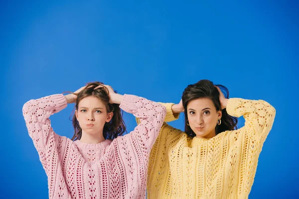 Attractive Women Sweaters Making Faces Looking Camera Isolated Blue — Stock Photo, Image