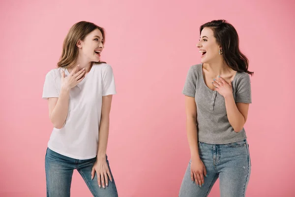 Aantrekkelijke Lachende Vrouwen Shirts Kijken Naar Elkaar Geïsoleerd Roze — Stockfoto