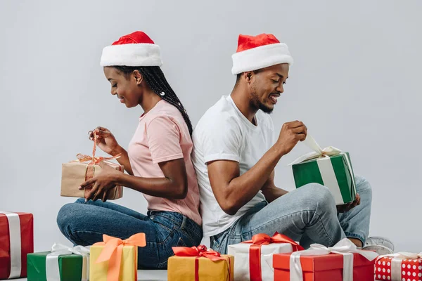 African American Couple Santa Hat Sitting Back Back Opening Presents — Stock Photo, Image