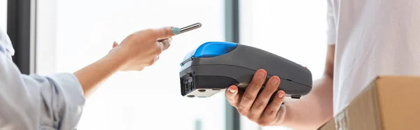 Panoramic Shot Delivery Man Holding Payment Terminal Woman Paying Smartphone — Stock Photo, Image