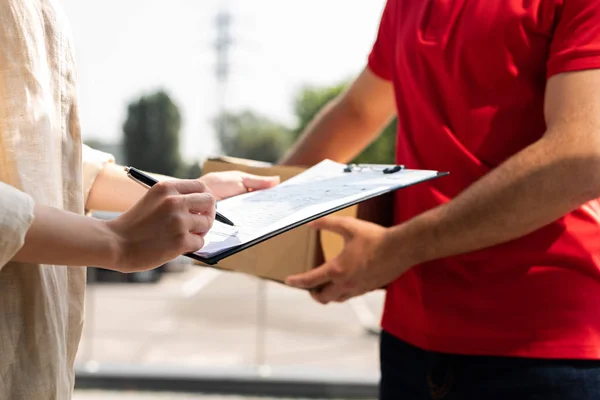 Cropped View Delivery Man Holding Clipboard While Woman Signing Paper — Stock Photo, Image