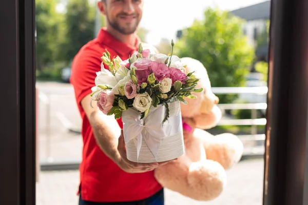 Cropped View Bearded Delivery Man Holding Teddy Bear Flowers — Stock Photo, Image