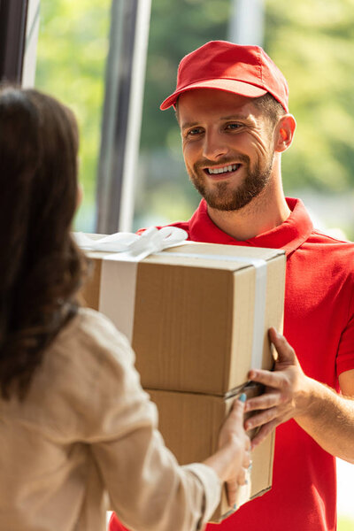 cropped view of woman receiving carton box from delivery man  
