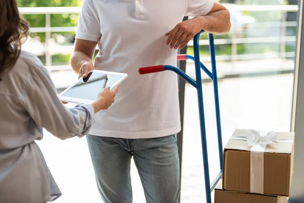 Cropped View Delivery Man Standing Delivery Cart Boxes Woman Digital — Stock Photo, Image