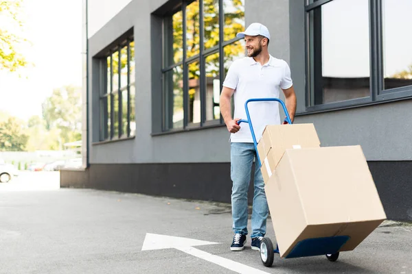 Happy Delivery Man Cap Walking Delivery Cart Building — Stock Photo, Image