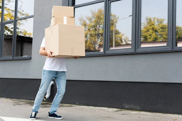 Delivery Man Denim Blue Jeans Covering Face While Holding Boxes — Stock Photo, Image