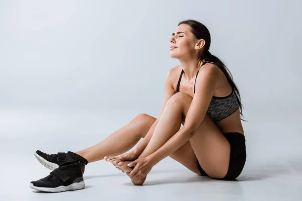 Suffering Brunette Sportswoman Foot Pain Grey — Stock Photo, Image
