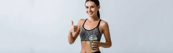 Panoramic Shot Smiling Sportswoman Holding Smoothie Showing Thumb Isolated Grey — Stock Photo, Image