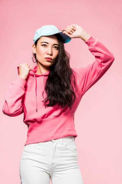 Attractive Pensive Asian Woman Pink Pullover Cap Looking Away Isolated — Stock Photo, Image