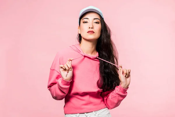 Attractive Asian Woman Pink Pullover Cap Looking Camera Isolated Pink — Stock Photo, Image