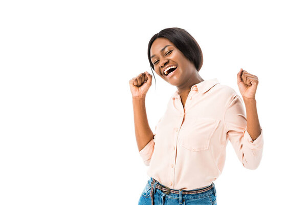 smiling african american woman showing yes gesture and looking at camera isolated on white 