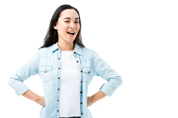 Aantrekkelijke Lachende Aziatische Vrouw Denim Shirt Knipogen Geïsoleerd Wit — Stockfoto