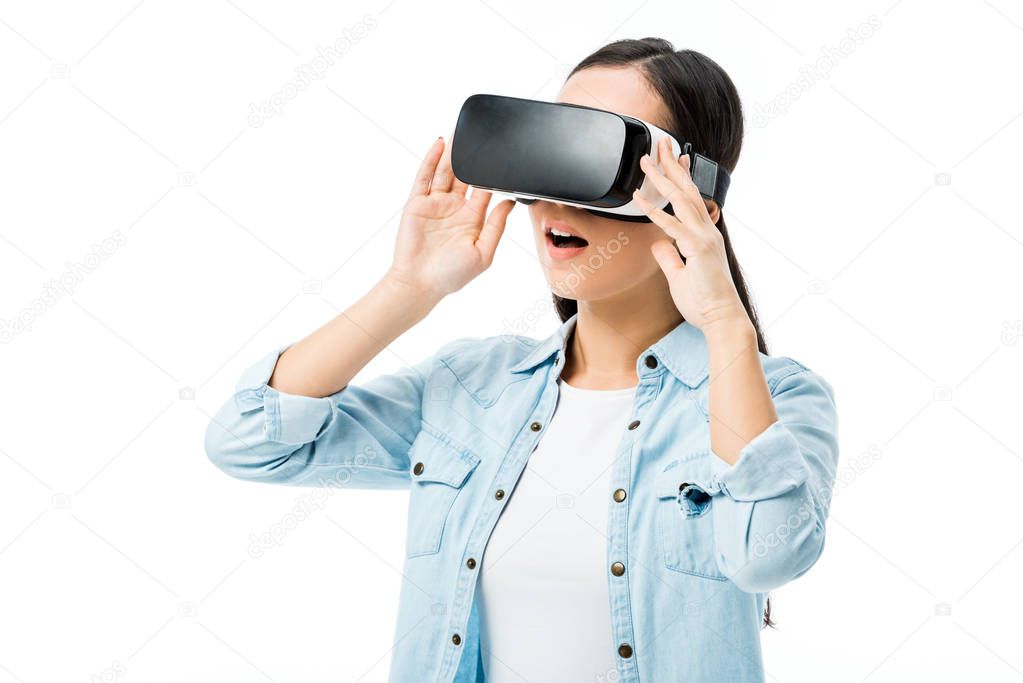 shocked woman in denim shirt with virtual reality headset isolated on white 