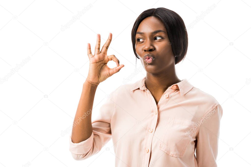 shocked african american woman showing ok gesture isolated on white 