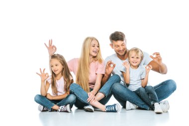 Mutlu ebeveynler ve çocuklar beyaz tabelayı gösteriyor 
