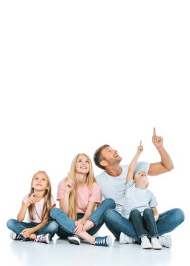 happy family pointing with fingers while looking up on white  clipart
