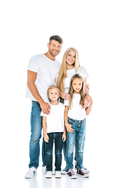 adorable children standing with happy parents and looking at camera on white