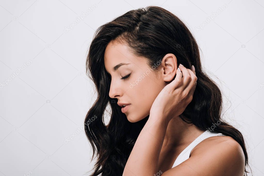 side view of tender brunette beautiful woman with long healthy and shiny hair isolated on grey