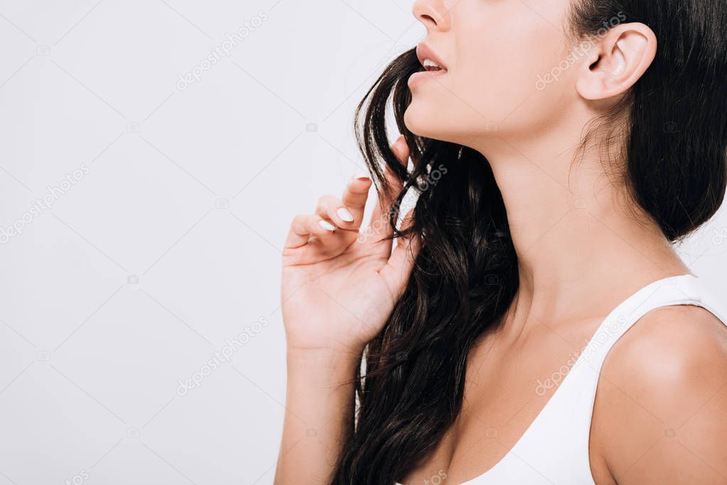 cropped view of brunette beautiful woman with long curly healthy hair isolated on grey