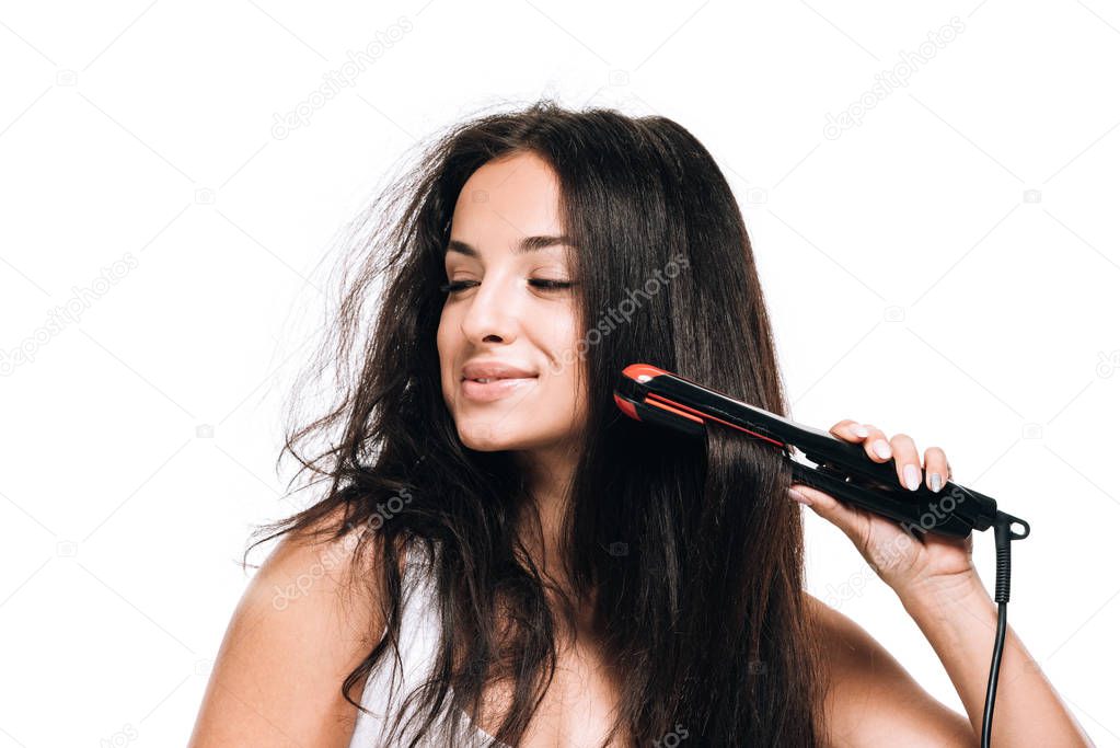 smiling brunette beautiful woman styling straight and curly hair with flat iron  isolated on white