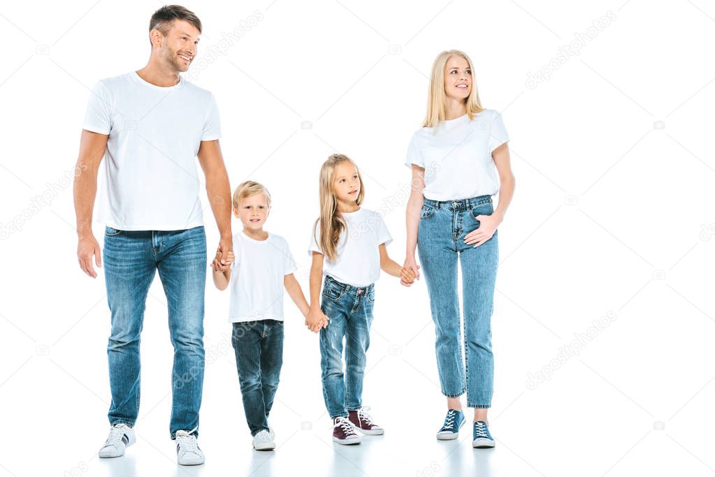 happy parents holding hands with cheerful kids on white 