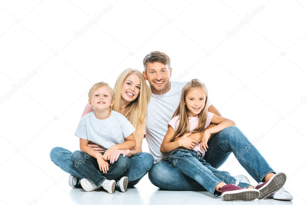 happy parents and kids in blue jeans sitting on white 