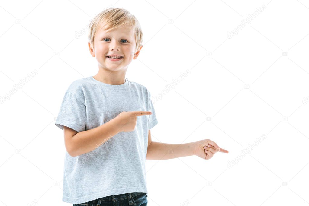 cheerful boy pointing with fingers isolated on white 