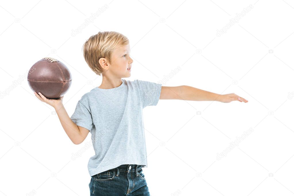 side view of boy holding rugby ball isolated on white 