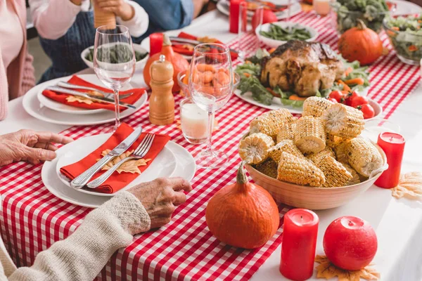 Cropped View Grandmother Sitting Table Holding Plates Yellow Leaves Thanksgiving — Stock Photo, Image