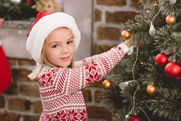 Cute Kid Santa Hat Sweater Decorating Christmas Tree — Stock Photo, Image