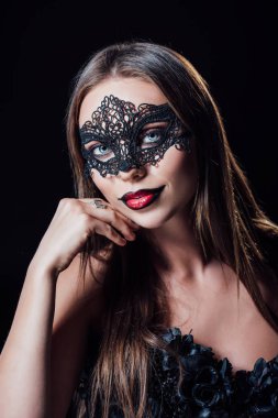 scary vampire girl in black gothic dress and mask isolated on black clipart