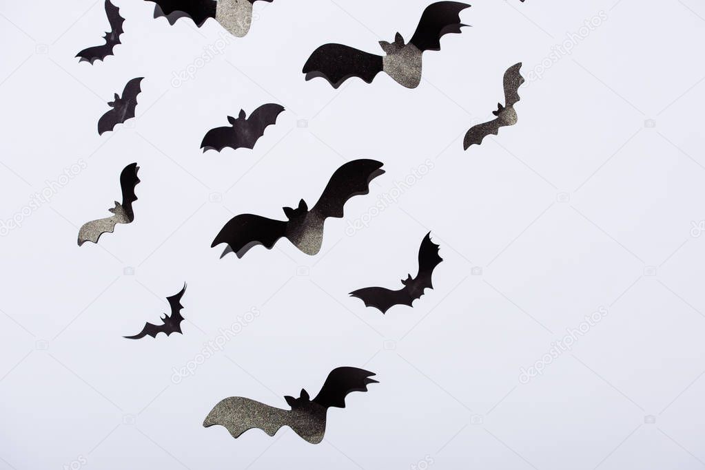 black paper bats on white background