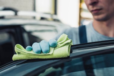 selective focus of car cleaner polishing car with rag clipart