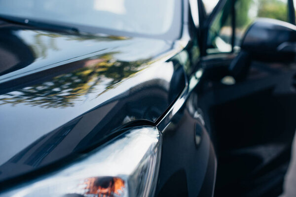 selective focus of black, polished modern car front side
