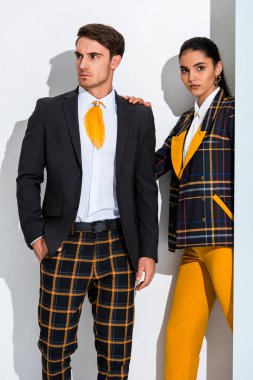 handsome man and attractive girl standing on white 