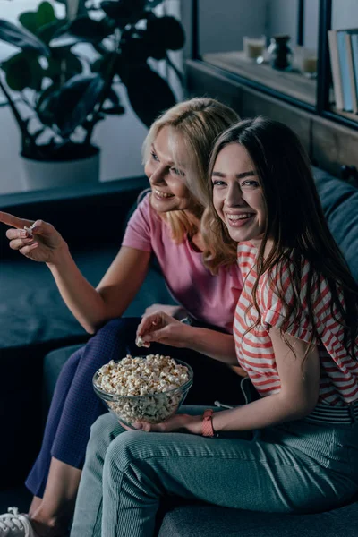 Cheerful Girl Looking Camera While Watching Mother Pointing Finger — Stock Photo, Image